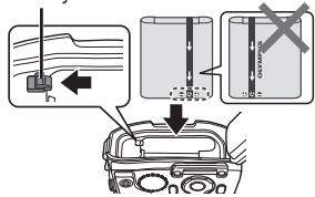 OLYMPUS TG 850 - Insert the battery while sliding the battery lock knob in the direction of the arrow. - 1