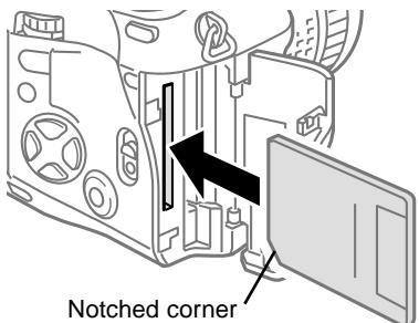 OLYMPUS CAMEDIA E-10 - While pressing down the round release on the card cover lock, slide and raise the card cover lock. - 1