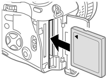 OLYMPUS CAMEDIA E-10 - While pressing down the round release on the card cover lock, slide and raise the card cover lock. - 2