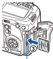 Diagram of a camera module with labeled parts and directional arrow indicating assembly or movement