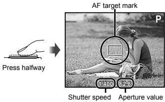 OLYMPUS D-705 - Press the shutter button halfway down to focus on the subject. - 1