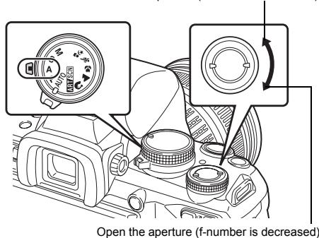 Open the aperture (f-number is decreased)