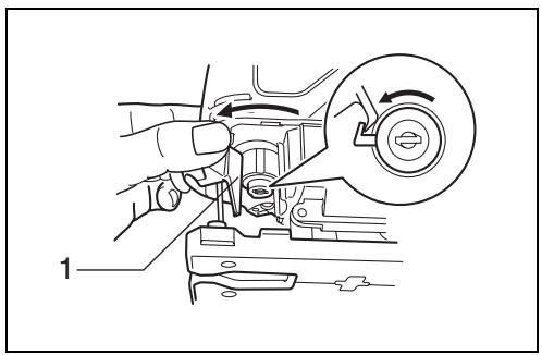 Technical diagram showing a hand operating a mechanical component with a circular inset highlighting the rotation direction.