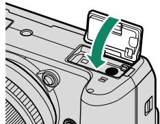 FUJIFILM X-H1 - Close the battery-chamber cover. Close and latch the cover. - 2