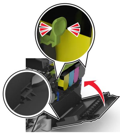 LEXMARK CX517DE - Appuyez sur les leviers de couleur verte situés de chaque côté de la bouteille de récepération de toner, puis retirez cette dernière. - 3