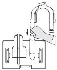 Diagram showing a hand using a U-shaped tube to interact with test tubes in a container, with an arrow indicating the process.
