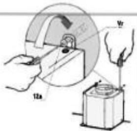 Technical diagram showing hands operating a mechanical device with labeled components and a magnified view of the component.