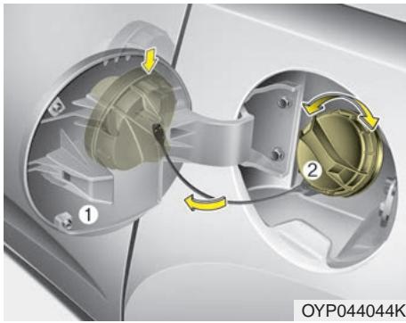 KIA Sedona YP (2014-2018) - Ouverture du volet du réservoir de carburant - 2