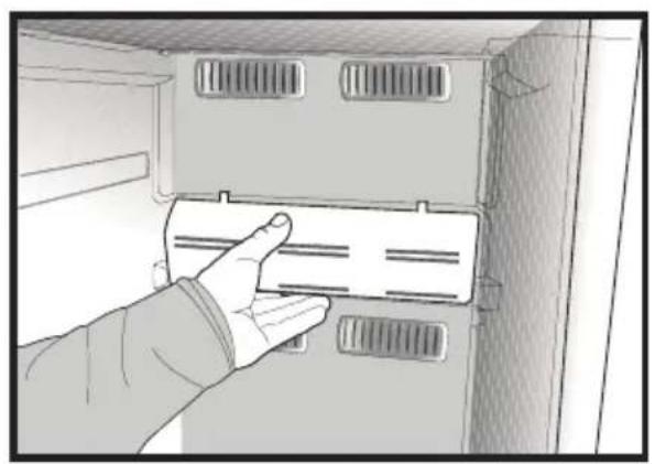 Hand inserting a plastic bag into a cabinet or rack (no text or symbols visible)