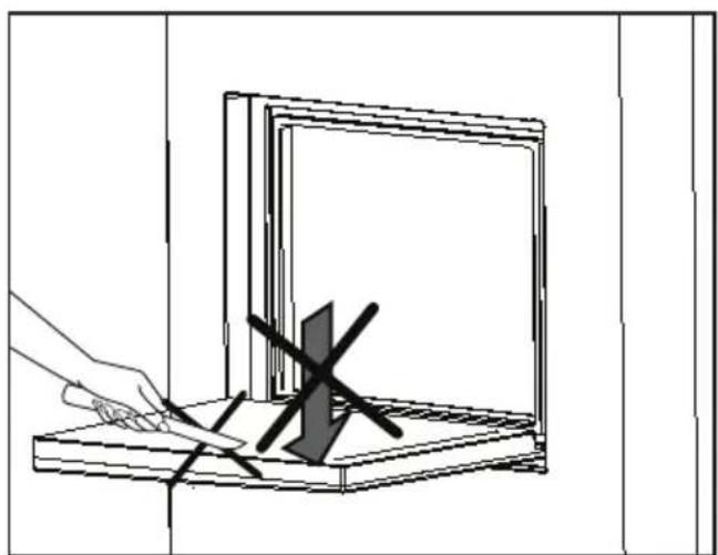 Line drawing of a hand using a tool to cut or mark a dark object on a wooden base (no text or symbols)