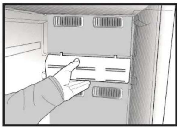 Hand inserting a plastic bag into a cabinet or rack unit (no text or symbols visible)