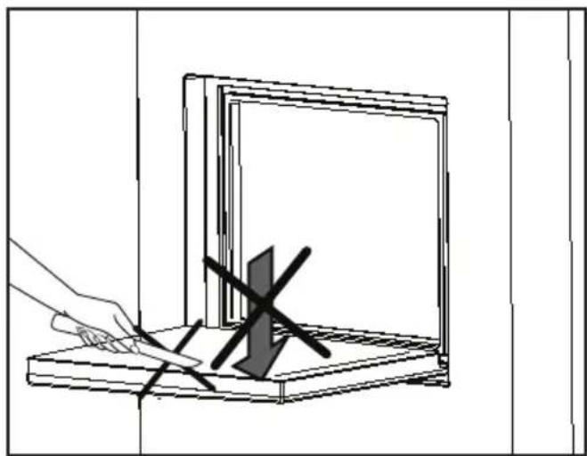 Line drawing of a hand using a tool to cut or mark a rectangular object on a wooden base (no text or symbols)