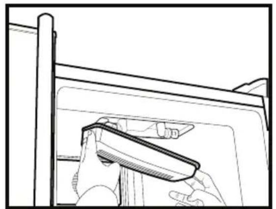 Line drawing of a hand using a tool to clean or adjust a component inside a vehicle (no text or symbols)