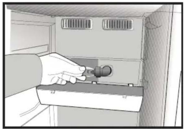 Illustration of a hand holding a small device inside a cabinet (no text or symbols visible)