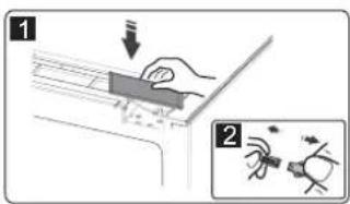 Diagram illustrating a hand holding a device with a downward arrow and a magnified inset showing a small mechanical component.