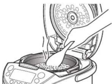 Tiger JKTB18U - Stir and loosen the reheated rice well, and even it out in the inner pot. - 1