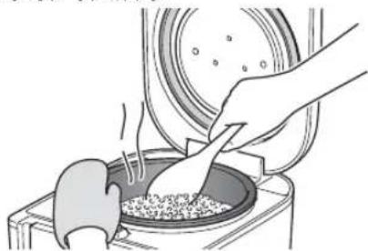 Tiger JAJA55U - Remuez bien et desserrez le riz rechauffé et égalisez-le dans la casserole interieure. - 1