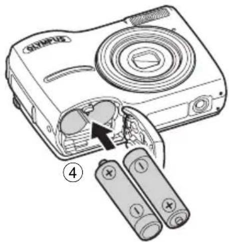 Diagram of a digital camera with labeled components and battery arrangement, showing internal components and battery terminals.