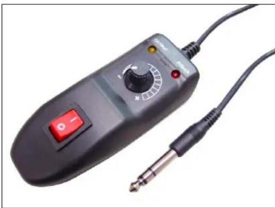 Close-up of a black analog audio device with control knob and external microphone (no visible text or symbols)