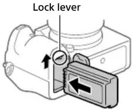 SONY Alpha A9 II - Insert the battery pack while pressing the lock lever with the tip of the battery until the battery locks into place. - 1