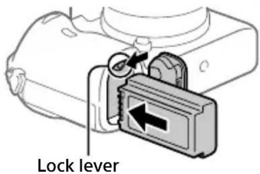 SONY ILCE7M3K - Insert the battery pack while pressing the lock lever with the tip of the battery until the battery locks into place. - 1