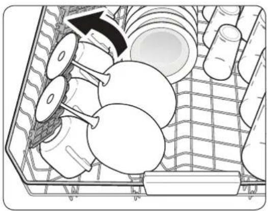 Interior view of a cleaning or packaging rack with multiple circular components and a black arrow indicating rotation (no text or symbols)