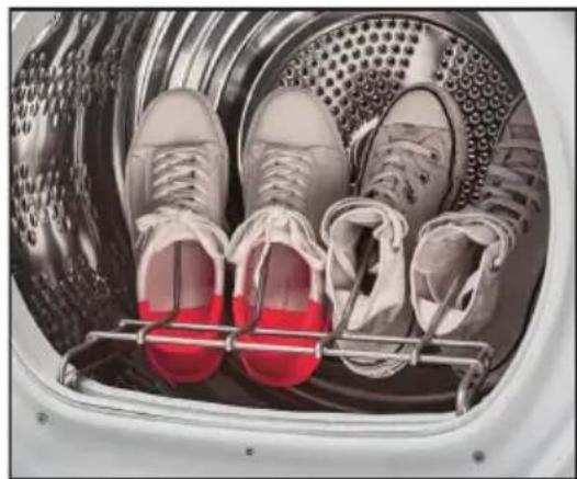 Interior view of a washing machine with two shoes on a rack, no visible text or symbols.