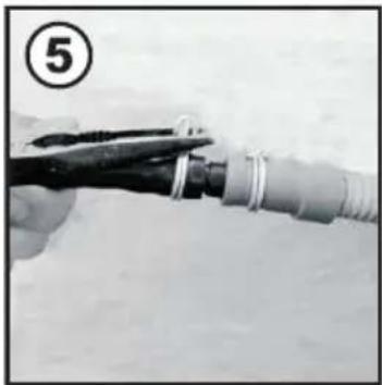 Close-up of a hand using pliers to cut a cylindrical cable or wire. No text or symbols visible.