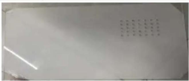 Cropped image showing a grid of handwritten or printed text on a white surface, possibly a label or identifier.