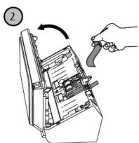 Diagram showing a hand holding a tool interacting with an open device, labeled with number 2 and directional arrow.