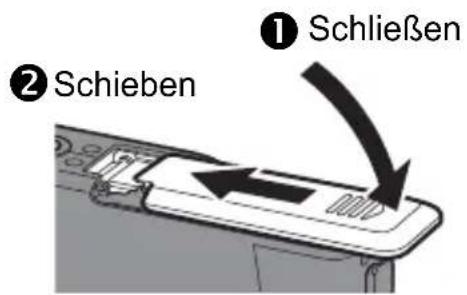 OLYMPUS Camedia X600 - Schlieben Sie den Akku-/Kartenfachdeckel. - 1