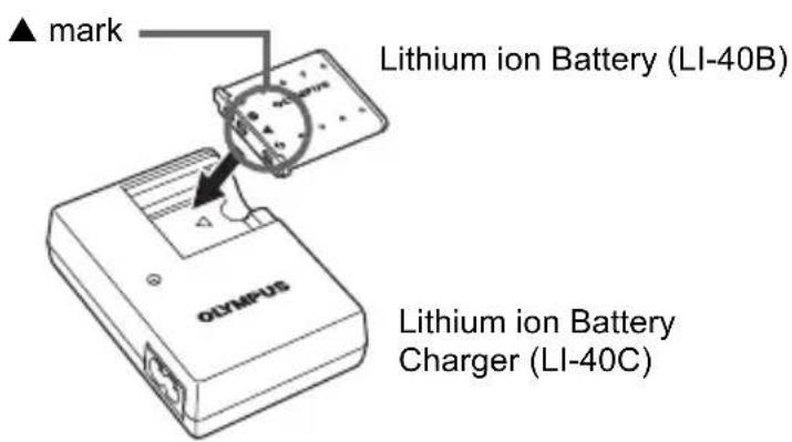 OLYMPUS Camedia X600 - Insert the battery into the charger. - 1