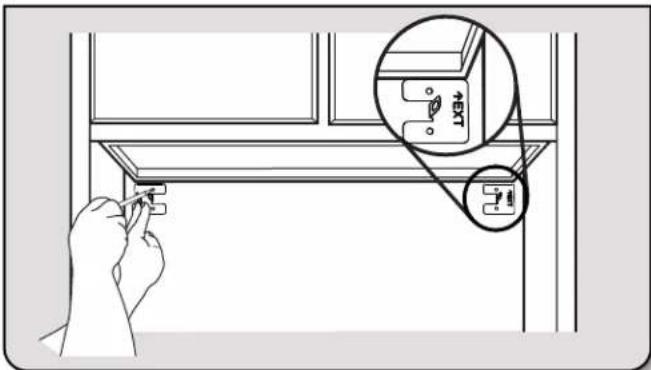 Diagram showing a hand inserting a component into a wall-mounted device, with an inset highlighting the component's internal structure.