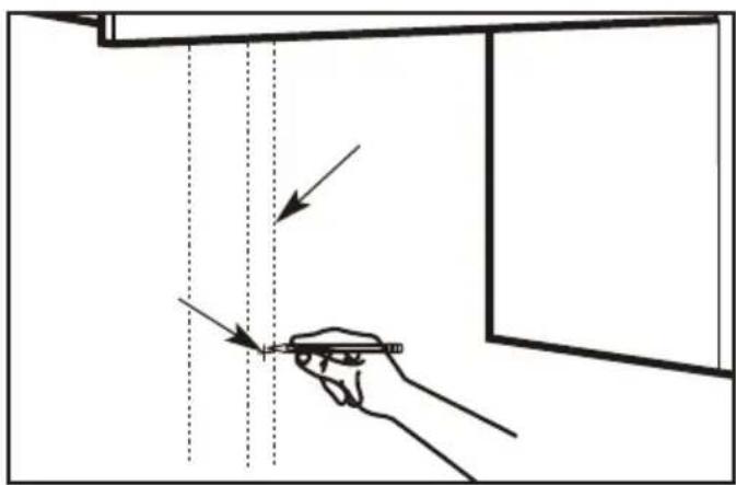 Diagram showing a hand holding a pen with arrows pointing to vertical dashed lines, indicating measurement or alignment steps.