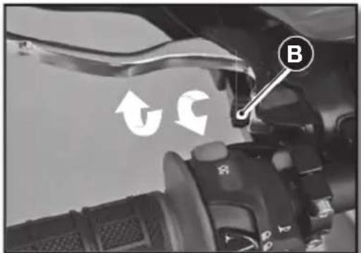 Close-up of a car interior with directional arrows and a labeled 'B' button, likely indicating movement or navigation.