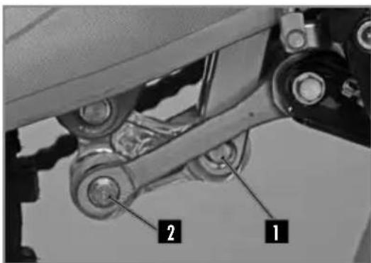 Mechanical assembly diagram with labeled parts 1 and 2, showing mechanical components and linkages.