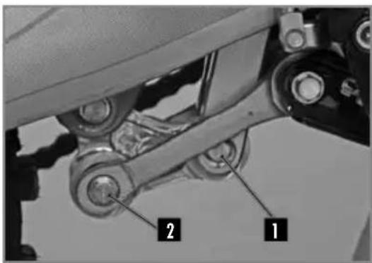 Mechanical assembly diagram with labeled parts 1 and 2, showing mechanical components and linkages.