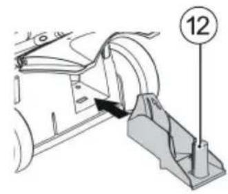 Technical diagram showing a mechanical assembly with numbered component 12 and directional arrow indicating motion or force.