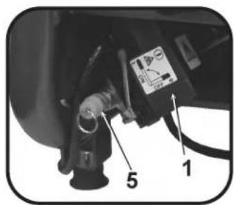 Close-up of a mechanical device with labeled parts 1 and 5, showing components like a dial indicator and connector.