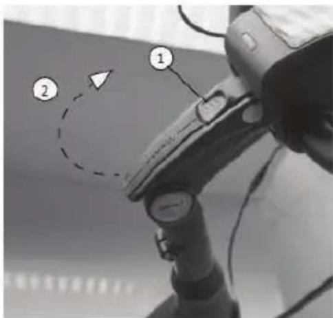 Diagram of a mechanical device with labeled parts and directional arrows, showing components like a dial indicator and a dashed circle with an arrow.