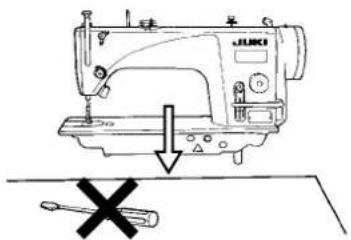 Diagram showing a sewing machine with a hammer and screwdriver, indicating a disassembly or repair operation.