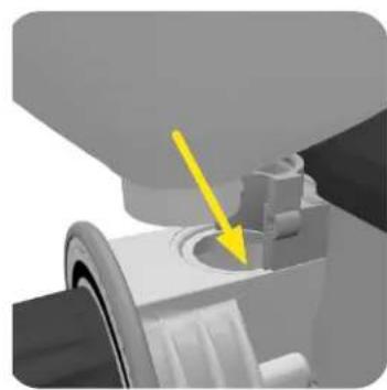 Mechanical component with a yellow arrow pointing to a circular feature (no text or symbols visible)
