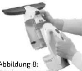 Close-up of hands operating a handheld device with a black handle (no visible text or symbols)