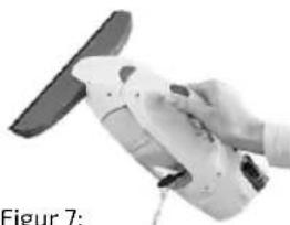 Hand holding a white industrial machine component, no visible text or symbols