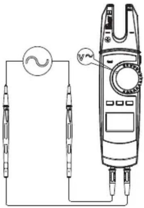 Diagram showing a circuit connection with two probes and a multimeter, including a waveform symbol and a close-up of the measurement device.
