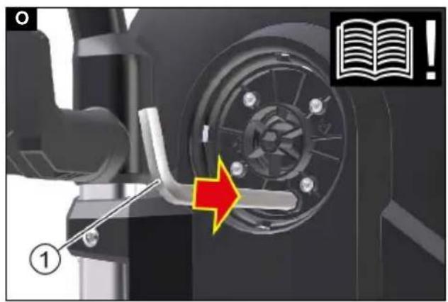Technical diagram showing mechanical assembly with labeled component and directional arrow, accompanied by an icon of an open book with a warning symbol.