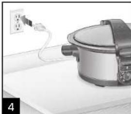 Electric cooker on a kitchen counter with power outlet (no visible text or symbols)