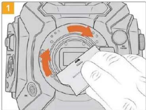 Diagram showing a hand inserting a device into a circular component with orange arrows indicating motion or flow.