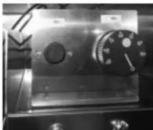 Close-up of a metallic industrial machine with a dial and control knob (no visible text or symbols)