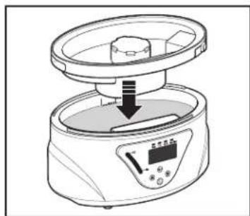 Line drawing of a kitchen appliance with a lid and control panel, showing a downward arrow indicating a process (no text or symbols present)